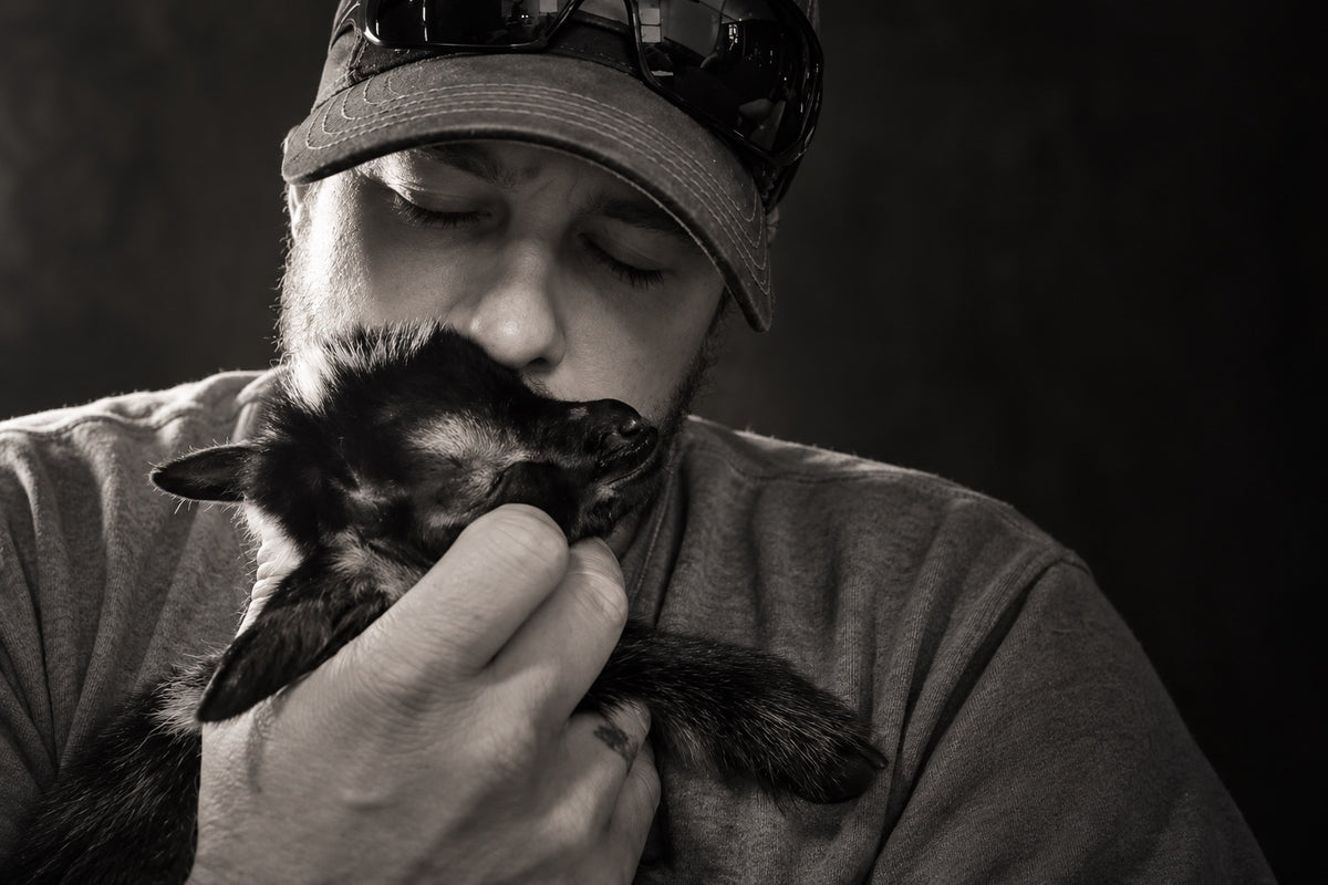 Justin Steinmetz holding baby Hope close in a black-and-white portrait